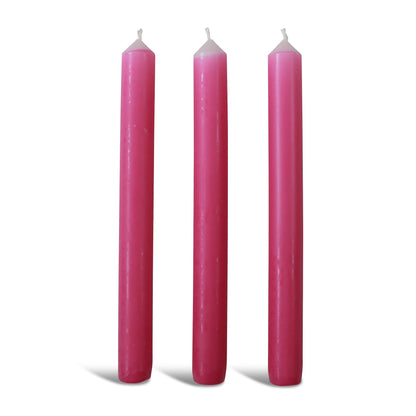 Three pink dinner candles