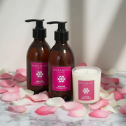 dopamine-decor-pink-soothe-rose-aromatherapy-bundle-hand-and-body-wash-and-lotion-and-candle-on-white-marble-background-with-pink-rose-petals